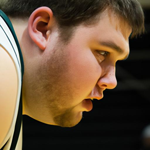 Focused Husson Eagles basketball player aiming for a perfect free throw.